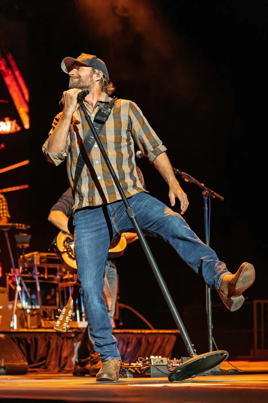 Dierks Bentley kicking a boot up beside the mic stand