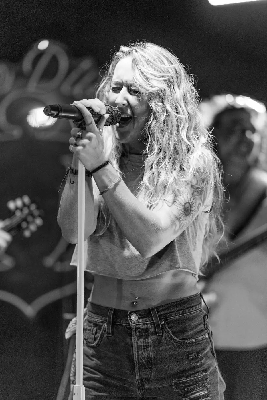 Scratch 2020 lead singer belting into the microphone, black and white
