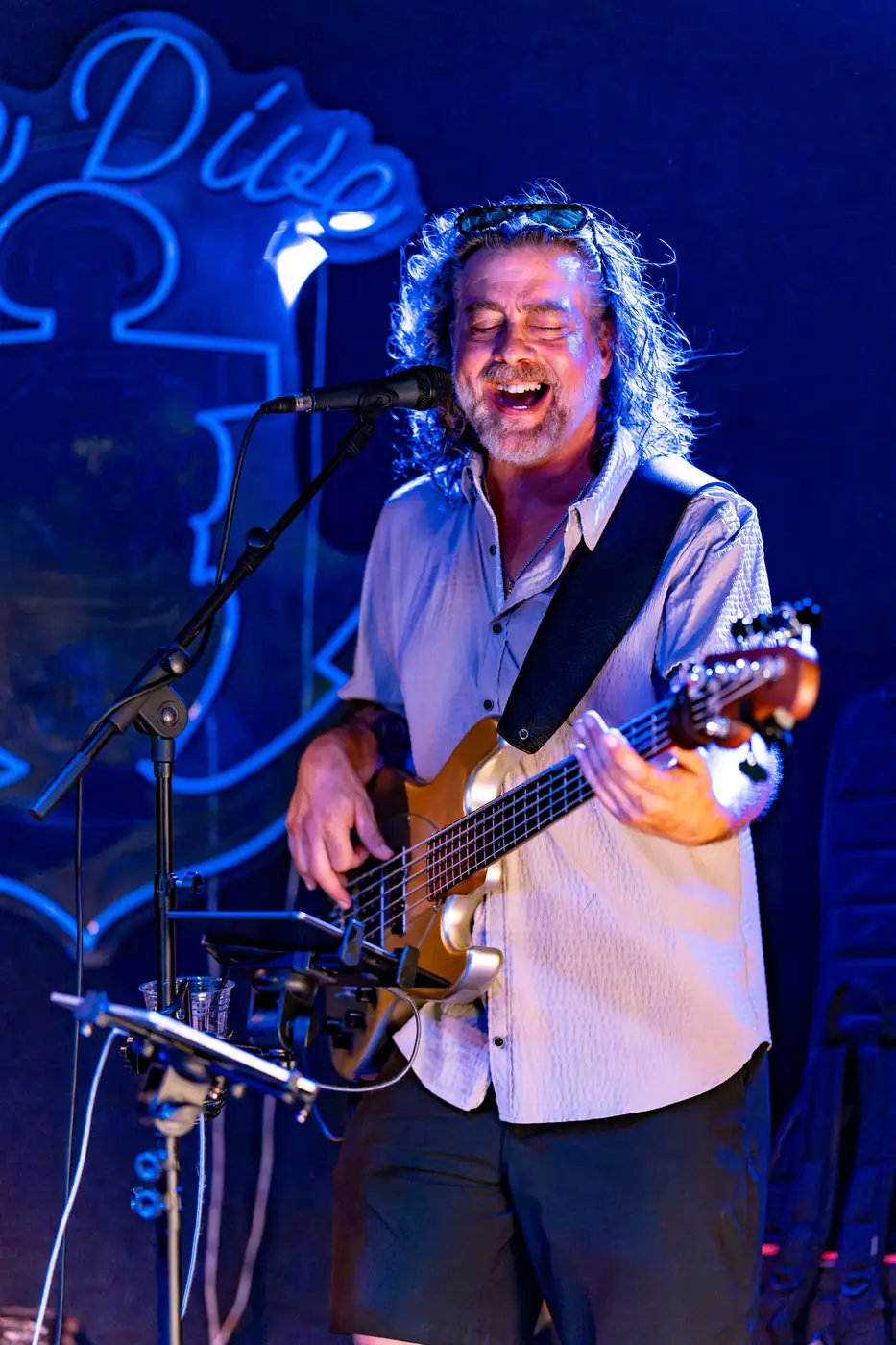 Scratch 2020 bassist grinning in blue light