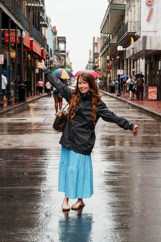 Hanna in a blue dress on a rain-slicked street in the French Quarter