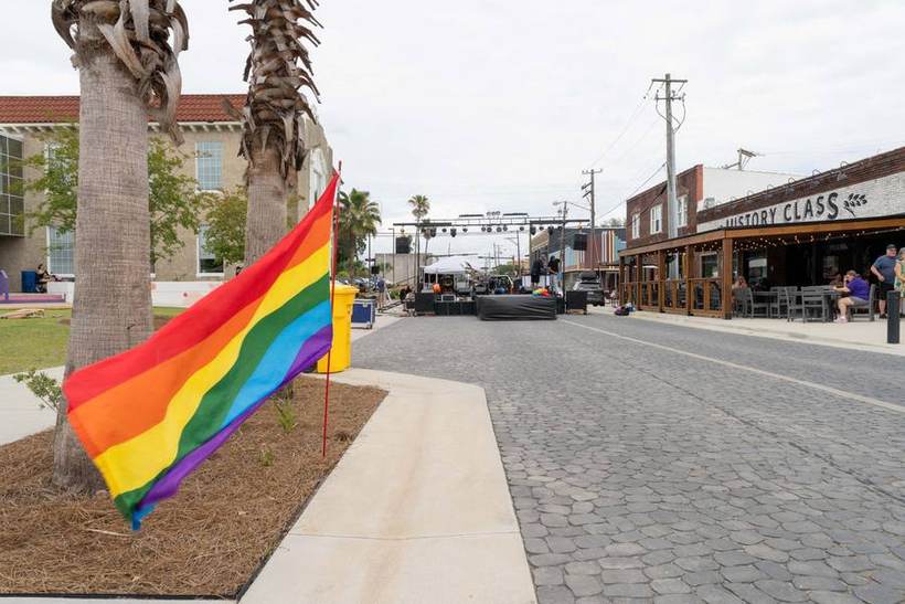 A rainbow flag flying over the brick street at NWFL Pride Fest in downtown Panama City